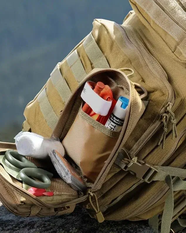 Khaki MOLLE pouch open on a backpack, with first-aid supplies as sample gear