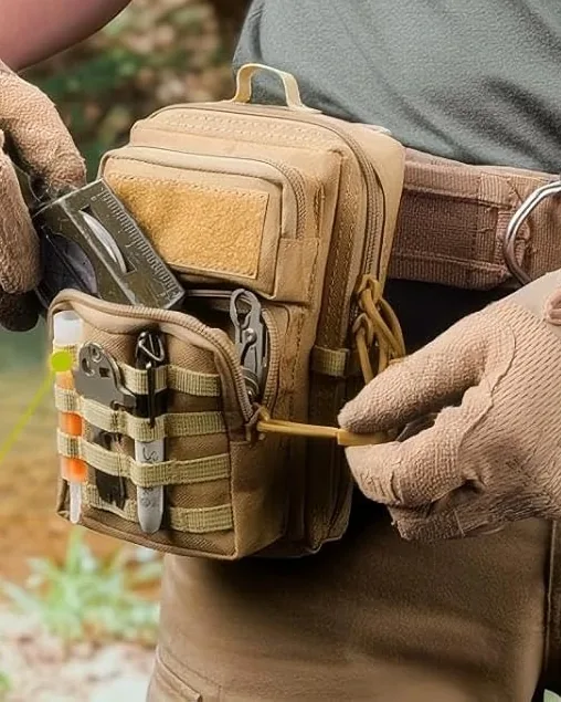 Gloved hands opening the front pocket of a khaki MOLLE pouch worn on a belt